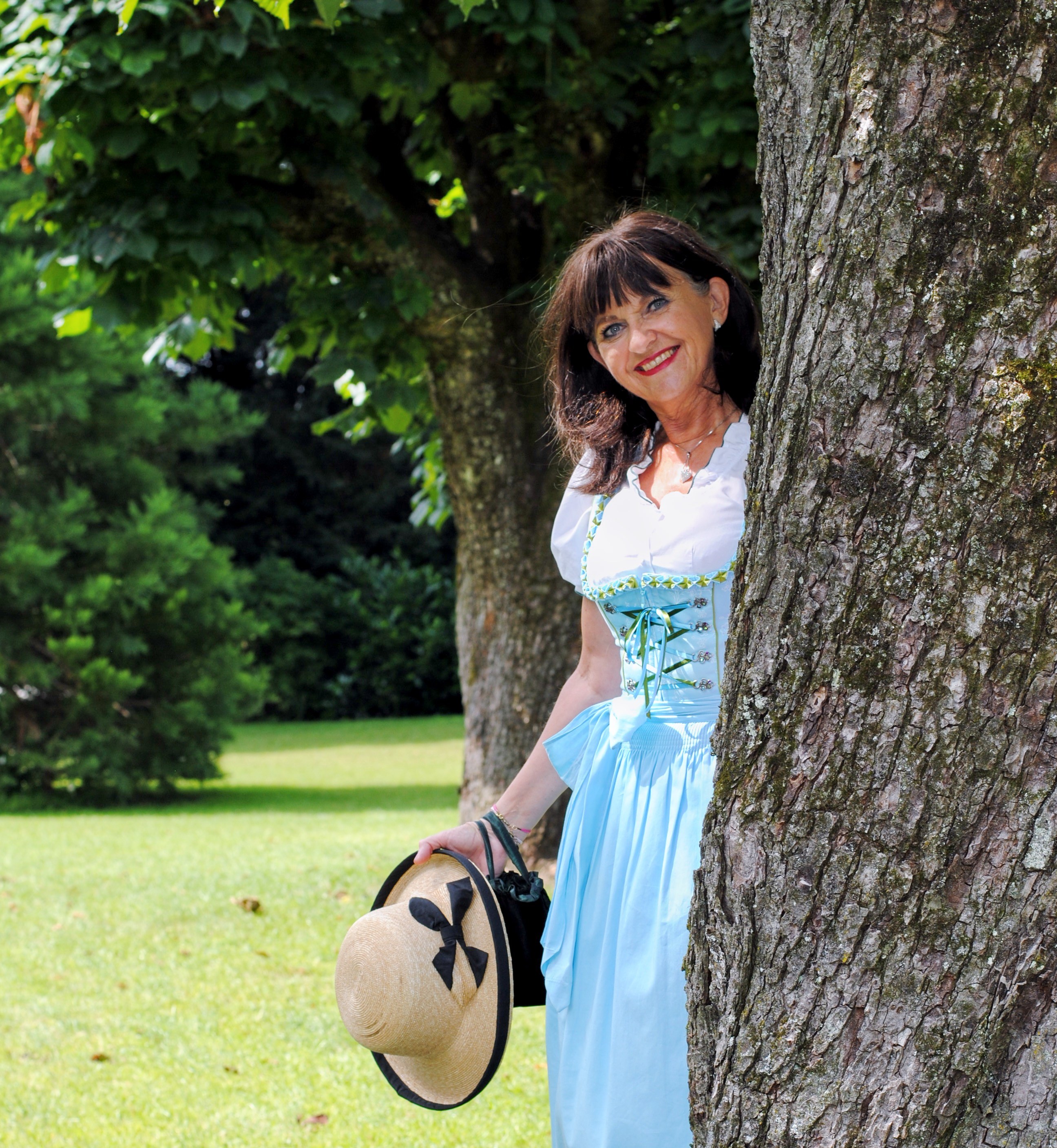 Dirndl im Park mit Hut